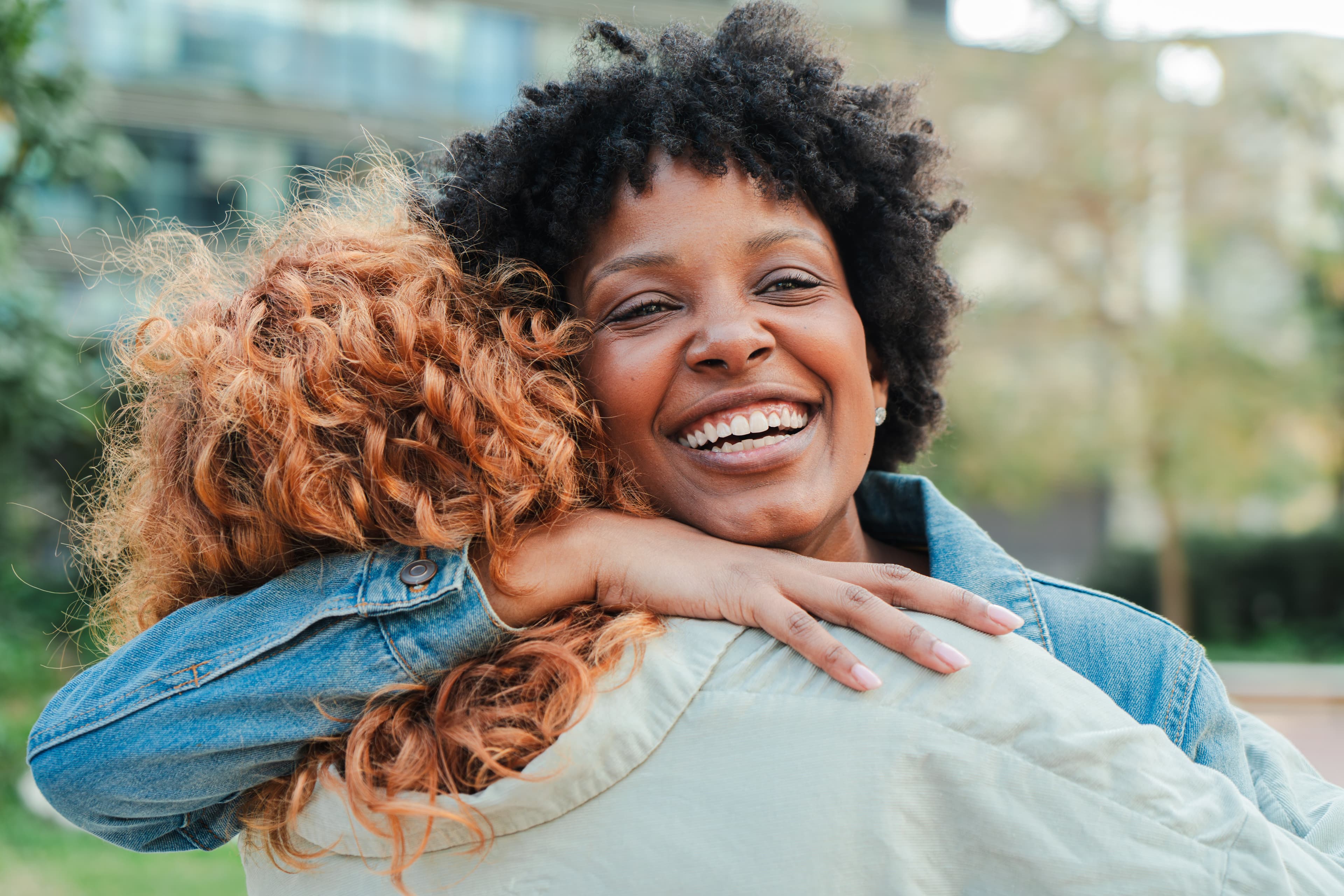 A woman hugging another — an expression of generosity